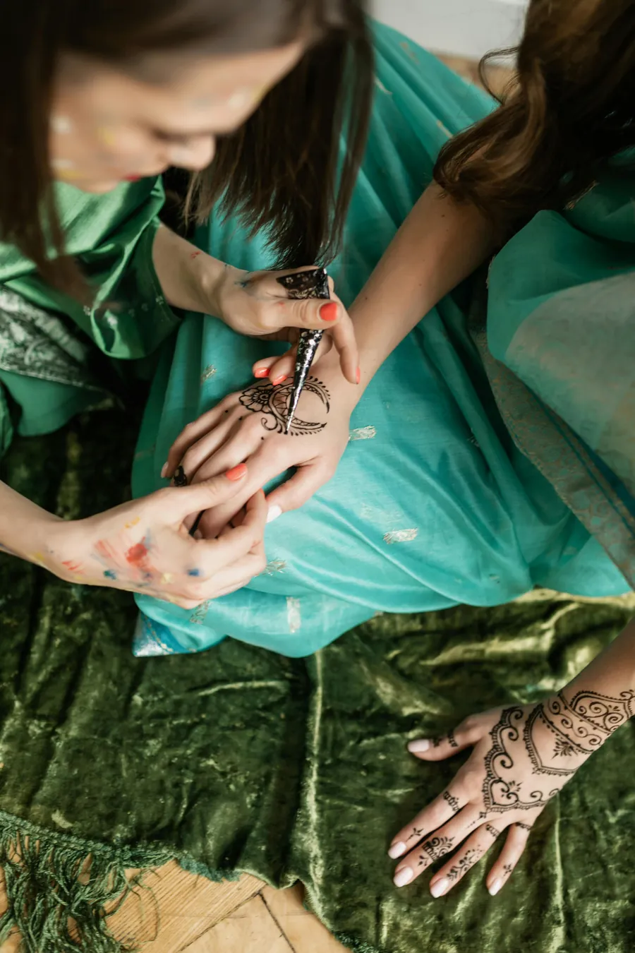Henna being applied to a guest's hand