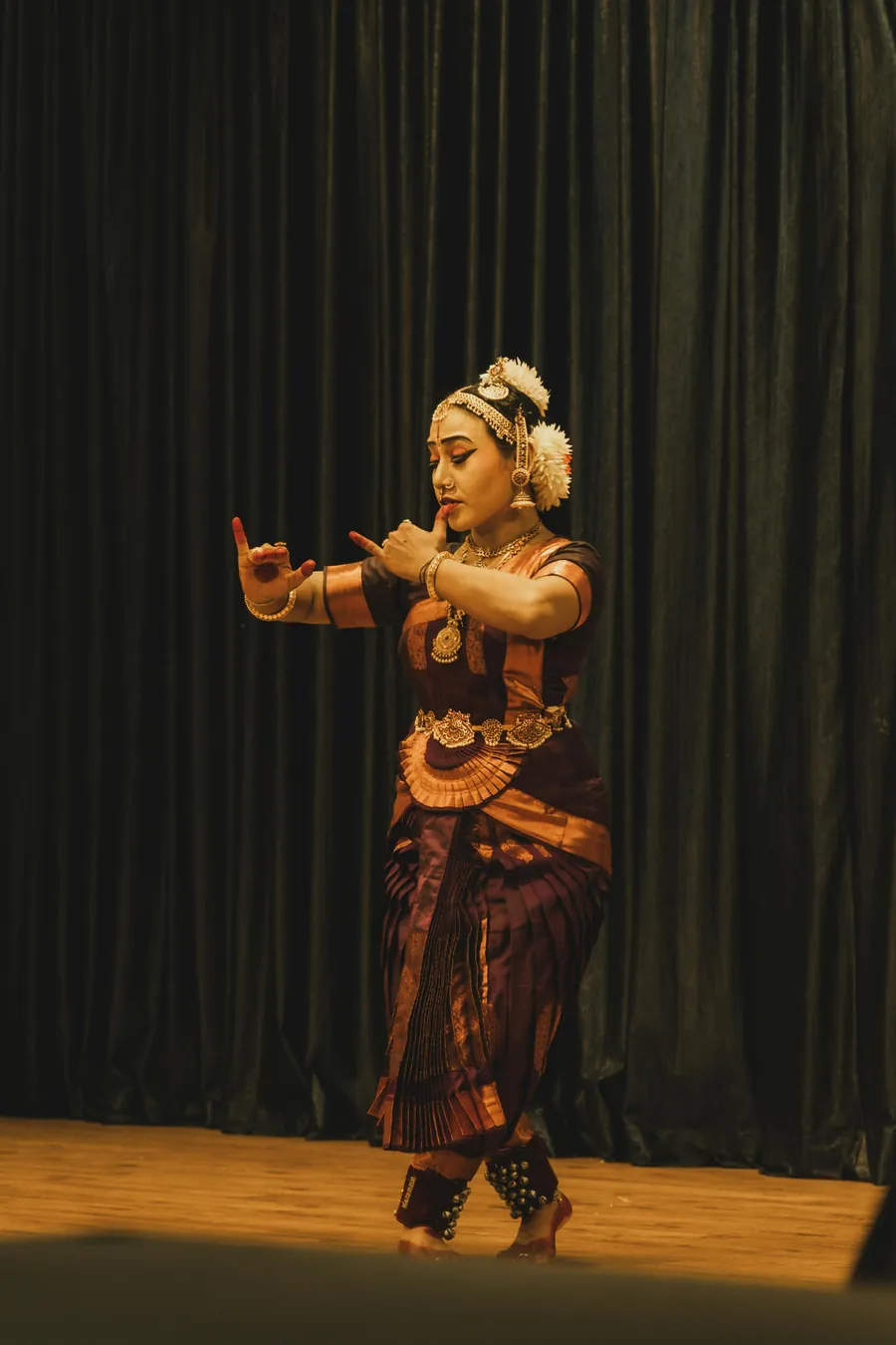 A Bharatanatyam dancer performing on stage