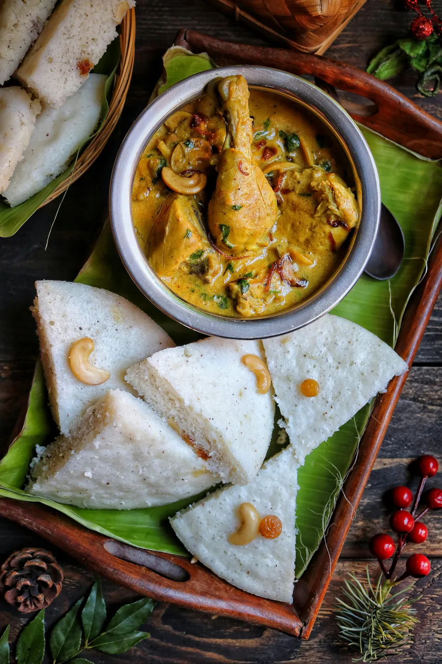 Idli and curry served on a banana leaf