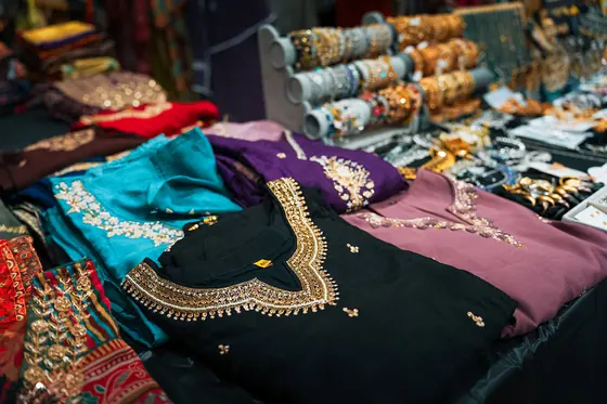 A market stall of sarees, kurtas and beaded jewellery